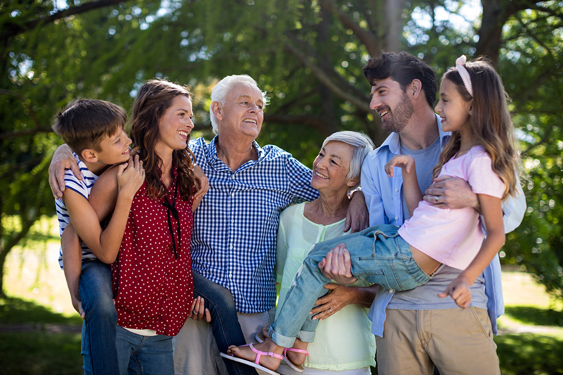 smiling-family-posing-together-in-park